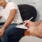 Man sitting in the psychologist s office and talking about problems